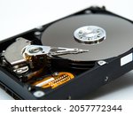 Small photo of Magnetic needles inside an open hard disk. Magnetic head of HDD. Selective focus