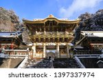 Golden roof of Yomeimon Gate and the Bell tower of Toshogu Shrine in Nikko, Tochigi, Japan, in a winter day with newly fallen snow. National Treasures of Japan. Toshogu is dedicated to Tokugawa Ieyasu