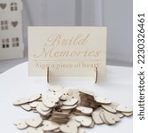 Small photo of Wooden decorative wedding guest book. Wedding accessories. Your wedding guestbook should be special and personalized. HEARTS FOR SWEET SAYINGS on laser-cut wooden hearts that your guests can sign on.