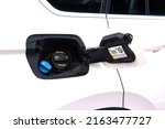 Small photo of Car fuel tank hatch. Gasoline Tank Hatch with adblue Hatch, Fuel Tank Hatch is open in white car. Car tank ready to be fuel up in gas station. Lack of available gasoline and diesel fuel.