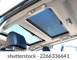 Small photo of Hatch in car roof. Panoramic glass sun roof in the car. Clean glass and view from inside to the sky. Double sunroof hatch with tinted glass.