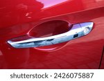 Exterior chrome car door handle with keyless entry button. Keyless entry car door handle with keyless go touch sensor. Automatic opening of a car door without a key. Car door handle. Access button.
