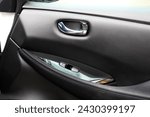 Small photo of Electric Car door trim with windows control. Car Inside Door Handle Interior. Leather Door trim. Front door trim of a Electric car. Electric Car interior.