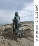Small photo of Tintagel, Cornwall, UK - April 10 2018 The King Arthur statue Gallos by Rubin Eynon stands on a rocky headland on the Atlantic coast of Cornwall.