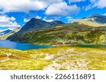 Small photo of Beautiful mountain and landscape panorama with untouched nature rivers lakes rocks stones and red huts houses in Rondane National Park Ringbu Innlandet Norway in Scandinavia.