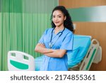 Smilling happy black female doctor standing in Recovery Room with beds and comfortable medical. Healthcare medical and medicine concept.