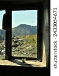 Small photo of Window of Dubs Hut bothy, a former miners hut located near Fleetwith Pike in the Lake District, UK, with view of High Stile mountain peak above Buttermere lake.