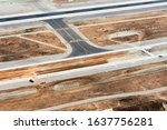 Aerial view of development construction in taxiway and runway in an international airport. Asphalt and concrete material for infrastructure and expansion work. 