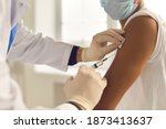 Small photo of Doctor in medical gloves giving Covid-19, AIDS or flu antivirus vaccine shot to African-American patient. Close-up of hands holding syringe and cleaning skin on upper arm before antiviral injection
