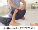 Small photo of Cropped image of a physiotherapist massaging and kneading a patient's leg provides medical care for sprained ligaments. Concept of rehabilitation and recovery after physical leg injuries.