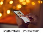 Find love online concept. Man holding mobile phone, looking at attractive young woman's profile photo on dating app and pressing red heart like button. Close-up, blur, romantic bokeh, soft focus