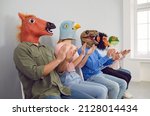 Audience in different funny bizarre silly animal masks applauding at interesting lecture or workshop. Group of happy foolish people with horse, bird, dino, ape and frog faces clapping hands at seminar