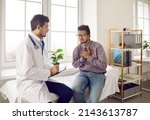 Small photo of Unhealthy ethnic man suffer from heartache or heart attack have consultation with cardiologist in private hospital. Sick young biracial guy struggle with pain chest consult with doctor in clinic.