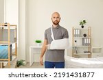 Small photo of Portrait of young Caucasian man with splint on arm after accident or trauma. Male patient with bandage or sling on hand or shoulder struggle with injury have rehabilitation. Recovery and rehab.