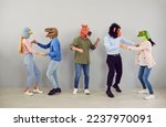 Small photo of Group of five strange people in animal disguise dancing and having fun together. Team of young men and women wearing funny wacky animal masks having fun at crazy party