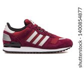 Small photo of VIENNA, AUSTRIA - AUGUST 10, 2017: Adidas ZX 700 burgundy sneaker on white background.