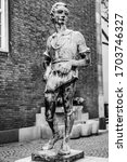 Small photo of Dusseldorf, North Rhine Westphalia, Germany - August 2019: Statue of a molder boy by Willi Hoselmann 1932 in the old town market square
