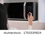 Woman Using The Microwave Oven...