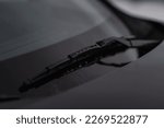 Small photo of Modern car windscreen wiper. Windshield wiper. Closeup of car windshield wiper.