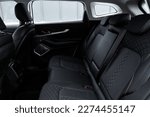 Modern car interior. Clean rear seats with the belts. Three rear seats in the row. Leather back passenger seats.