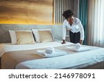 Small photo of Please make up my room. Maid cleaning the room with please make up my room sign on the door. Opened door of hotel room in morning.Hotel, door open. Clean and elegant accommodation service.