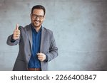 Businessman smiling with arms...