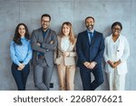 Small photo of Portrait of multi-ethnic male and female professionals. Business colleagues are standing against wall. Confident individuals make a confident team. Diverse group of confident businesspeople