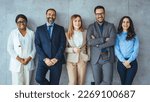 Small photo of Portrait of multi-ethnic male and female professionals. Business colleagues are standing against wall. They are in formals at office. Confident individuals make a confident team.