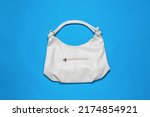 A Large White Leather Bag On A...
