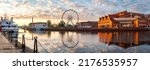 Gdansk, Poland. Panoramic view of ferris wheel and Gdansk sign at Motlawa river during sunrise. Eastern Europe travel destination at Baltic sea
