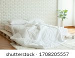 Small photo of Messed bed with white pillow and duvet blanket with natural light in bedroom in the morning,Messy bed after wake up,Messy bed and Cozy Bedroom Concept