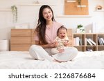 Small photo of Adorable newborn baby smile and relax in mother arm safety and comfortable.Healthy Asian newborn infant baby laughing with happiness good moment.Mother holding infant baby.Newborn Baby concept
