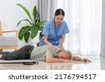 Small photo of Senior Asian man falling down from chair and nurse take care beside at home. Accident in elderly man down on the floor lose consciousness or hearth attack. Elderly symptom and sudden pain. Elder care