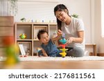 Small photo of Asian mom teaching baby boy learning and playing toys for development skill at home or nursery room. Happiness mother and baby spending time together at warmth place. Good moment with mom and baby