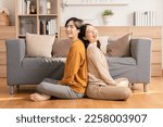 Small photo of Asian young couple smile and laughing with positive emotion and loving together at warmth place. Attractive man and woman spending time together at home. Couple love and Valentine's Day concept