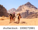 Caravan of camels walking in the Wadi Rum desert in Jordan on a sunny day
