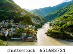 Small photo of Confluence of two rivers Alaknanda and Bhagirathi give rise to the holy river of Ganga / Ganges at one of the five Prayags called Dev Prayag. Lush greenery in monsoons on the mountains. sunrise. India