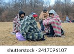 Small photo of Bihac, Bosnia and Herzegovina, 23 December 2020: Group of refugees freezing in food line during cold winter day. Hundreds of migrants freezing in camp Lipa. Inhumane condition. Balkan route.