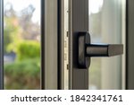 Aluminum window detail. Metal door frame open closeup view. Energy efficient, safety profile, blur green outdoor background