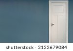 White Door Closed On Blue Wall...