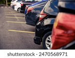 Many cars are parked in a large ...