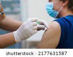 Small photo of Man getting vaccinated against covid. Vaccination routine, adult immunization schedule. Seasonal virus protection, monkeypox vaccine. Outbreak disease prevention. Medical nurse hold injection syringe
