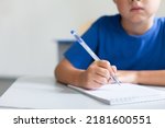 Writing hand of school child on ...