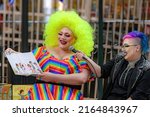 Small photo of Saint John, NB, Canada - June 5, 2022: A drag queen and king read children's stories at the Drag Story Hour in Market Square. Focus on the queen.