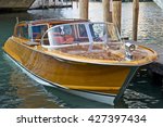 VENICE, ITALY - AUGUST 11, 2012: Wooden motorboat photographed in Venice channels.