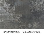 Old black anthracite gray grey vintage worn geometric arabesque shabby mosaic ornate patchwork motif porcelain stoneware tiles stone concrete cement wall texture background