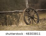 Old Wagon Wheel Near The Fence