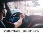 young man driving a business car. trip of a businessman in sunny weather.
