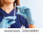 Vial vaccine and disposable syringe for injection in doctor hands