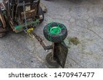 Small photo of Photo of a worn out tire on a sulky attached to a mower tied on with weedeater string.